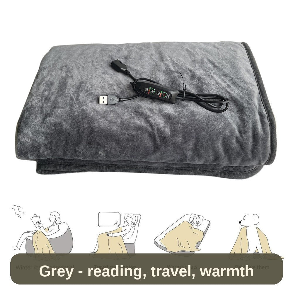 USB Heated Blanket in grey, folded with its controller - for reading, travel, warm sheets or a cosy lap.