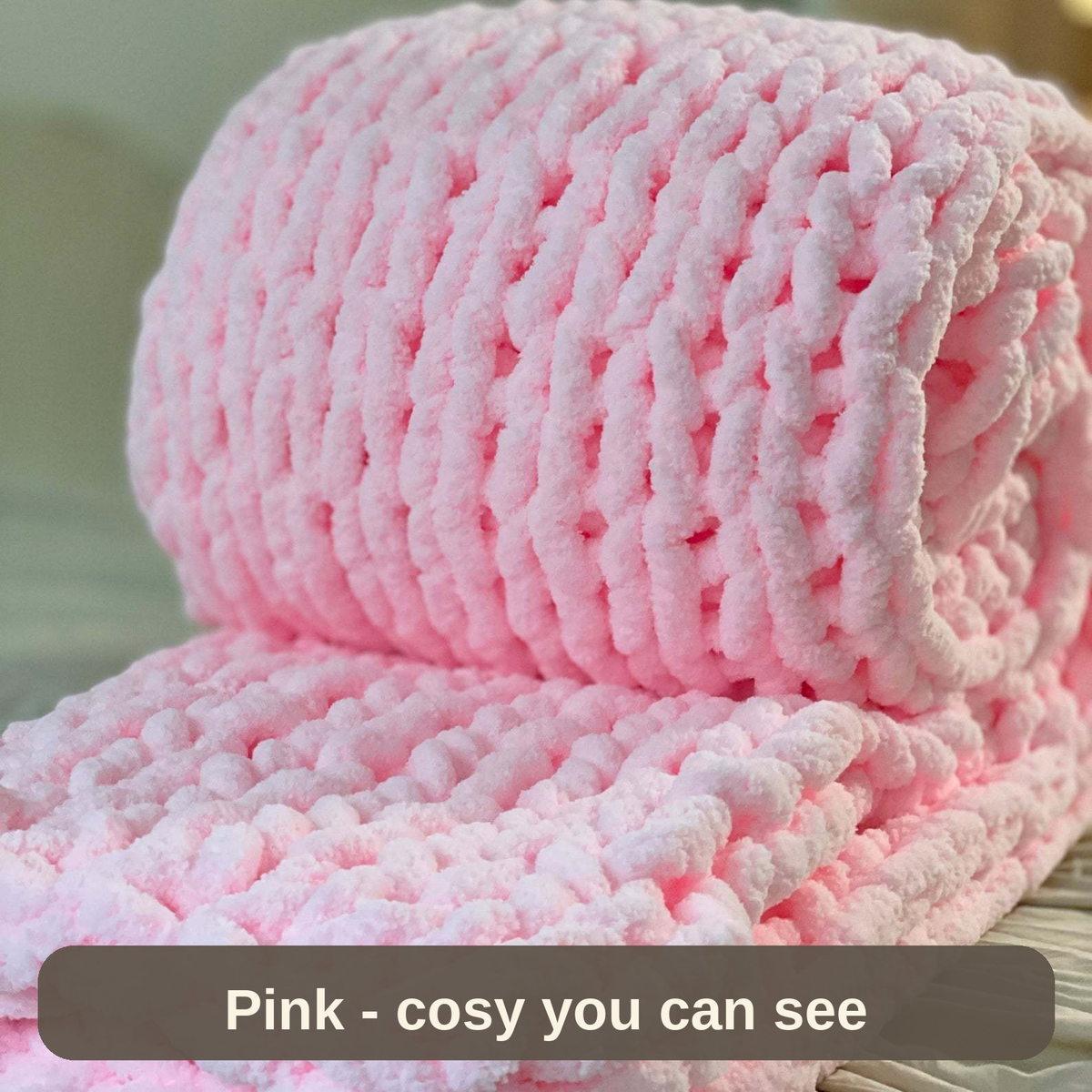 Knitted Weighted Blanket in soft pink, rolled to show the thick chunky knit - cosy you can see.