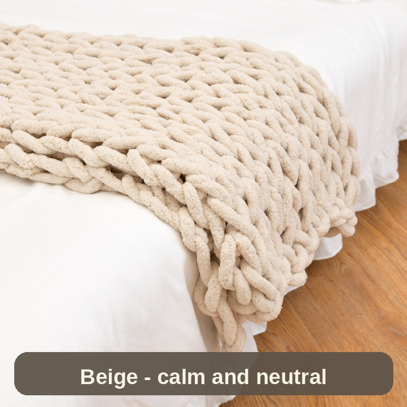 Knitted Weighted Blanket in warm beige across the foot of the bed - neutral, calm and easy to style.