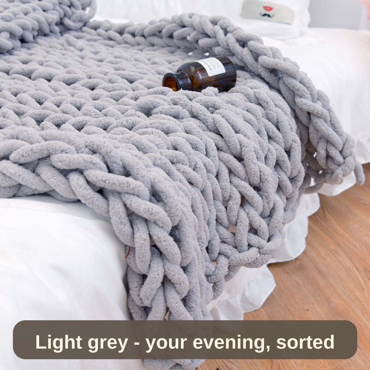 Light grey weighted blanket on the bed with a book resting on top - your evening, sorted.
