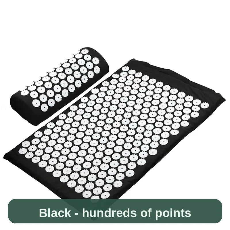 Black acupressure set laid flat - hundreds of gentle pressure points across the mat and pillow.