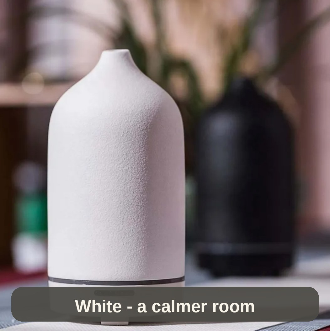 White Ceramic Diffuser softly lit beside the black one - a calmer room starts with scent.