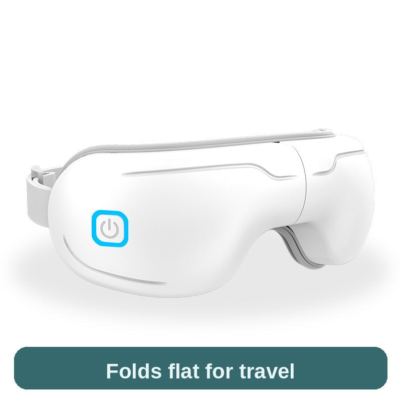 Eye massager in white, side view showing the power button - lightweight and foldable enough for travel.